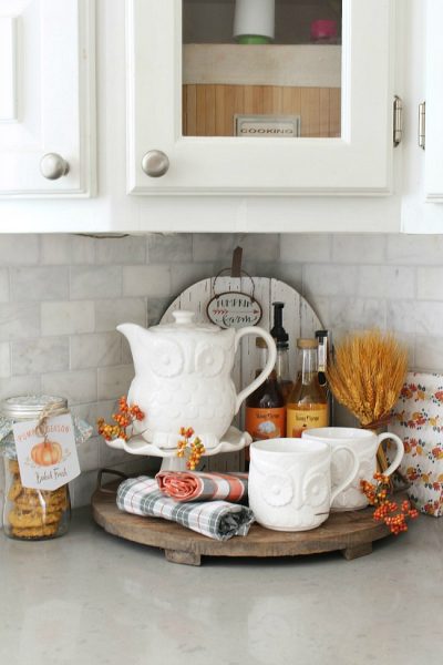 Fall beverage bar with owl tea set and flavored syrups.