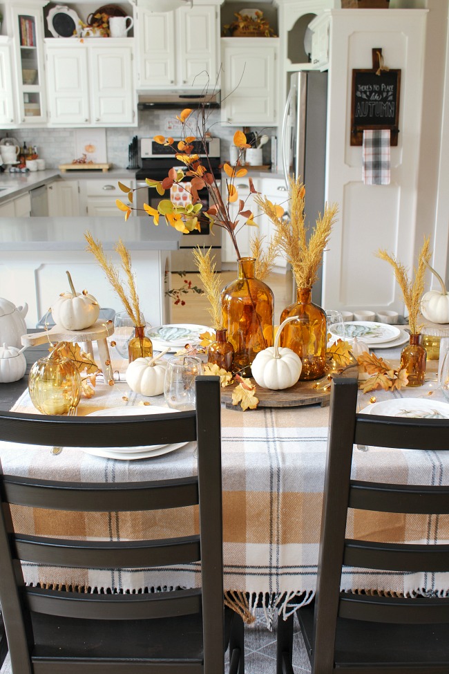 Harvest moon fall tablescape ideas for fall or Thanksgiving. Beautiful amber glass and muted fall colors in a farmhouse style kitchen.