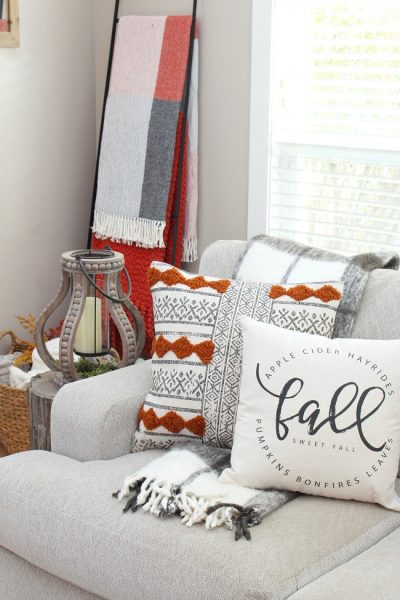 Cozy fall living room with fall pillows and cozy throws.
