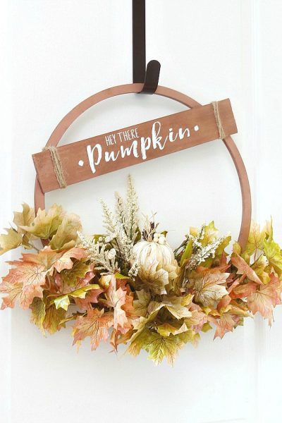 Beautiful copper hoop wreath for fall with 'Hey There Pumpkin' sign.