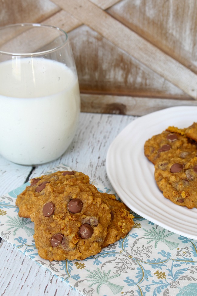 Oatmeal pumpkin chocolate chip cookies with a glass of milk.