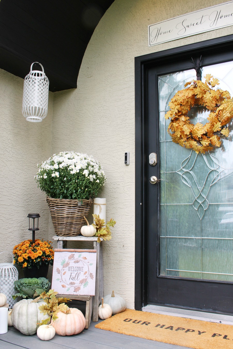 Colorful fall front porch with mums, pumpkins and a few vintage touches.