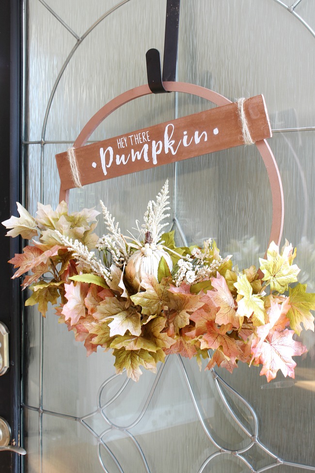 Beautiful copper hoop wreath for fall with 'Hey There Pumpkin' sign.