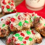 Christmas 7 layer bars with red and green chocolate candies on a holiday plate.