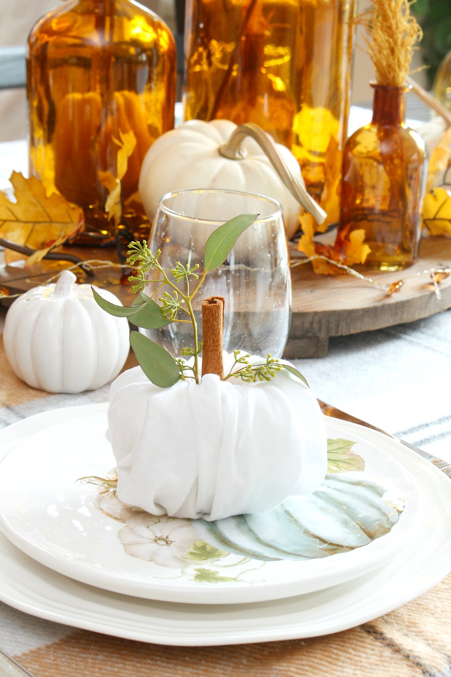 Thanksgiving place settings with cute napkin fold pumpkins.