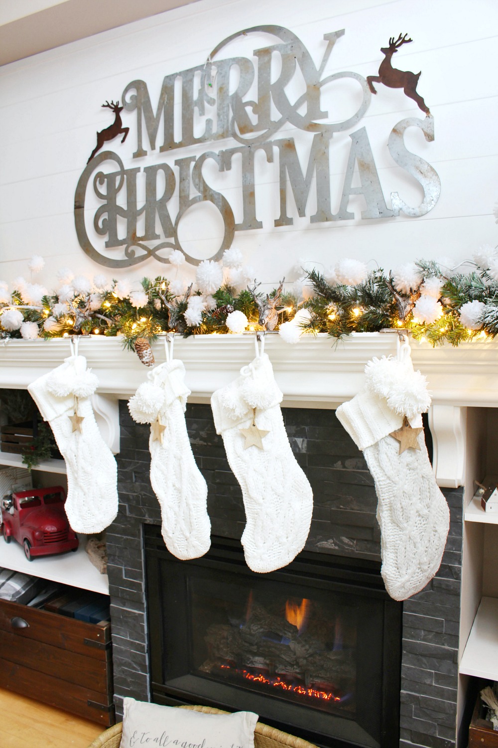 Neutral Christmas mantel decor with large metal Merry Christmas sign.