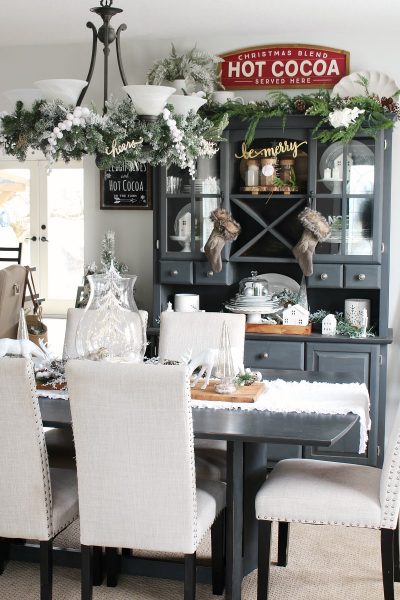 Farmhouse style Christmas dining room decor with black buffet and hutch.
