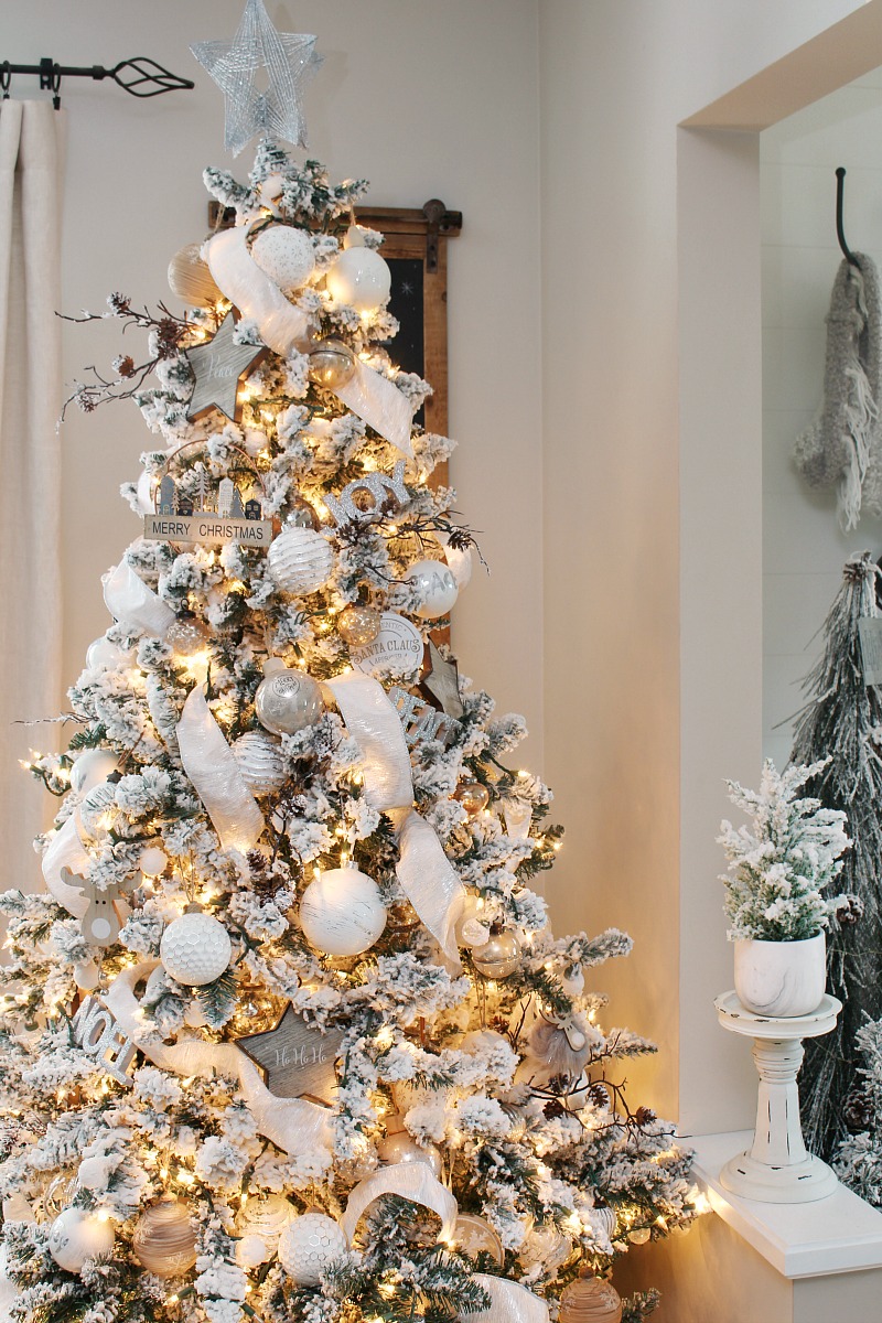 Flocked Christmas tree decorated with metallics and neutrals.