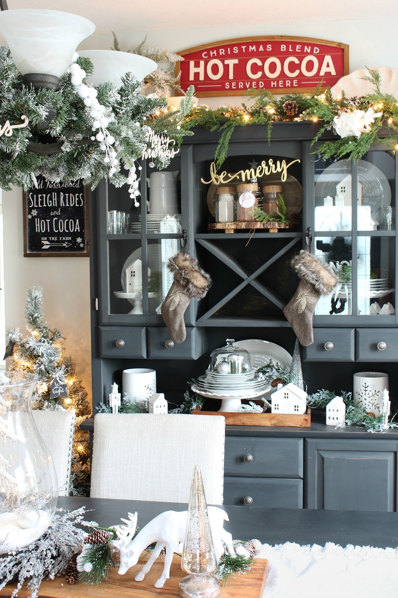 Farmhouse style Christmas dining room decor with black buffet and hutch.