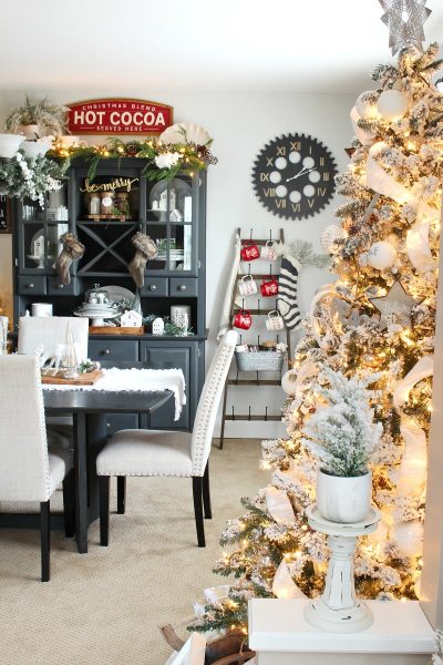Beautiful Christmas dining room decor with flocked Christmas tree.