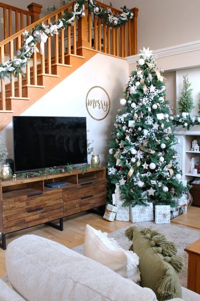 Neutral farmhouse style family room decorated with greens and metallics.