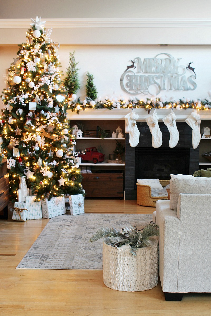 Cozy family room decorated for Christmas with green, white, and metallics.