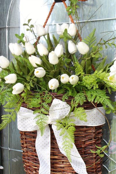 Pretty tulip wreath in a willow basket with gold polka dot ribbon.