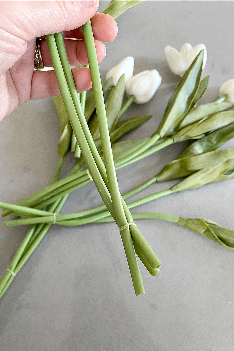 Faux tulip stems tied together with clear elastic for a tulip wreath.
