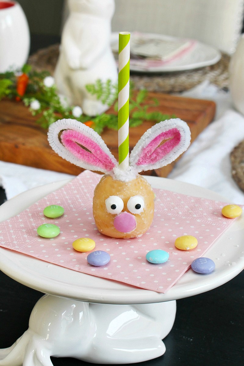 Cute Easter bunny donut holes on a cake stand.
