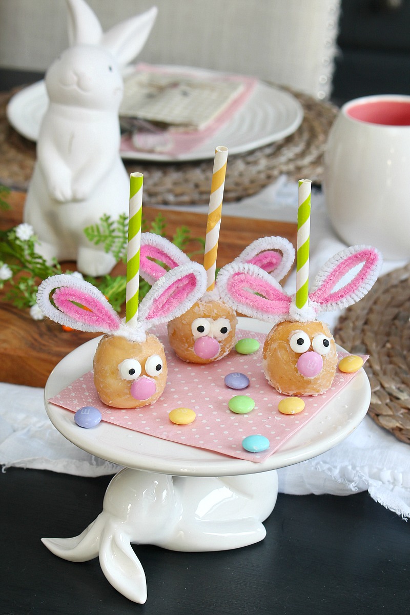 Cute Easter bunny donut holes on a cake stand.