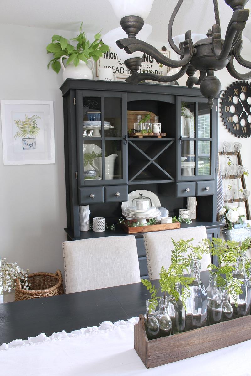 Farmhouse style dining room decorated for summer with blues and greens.
