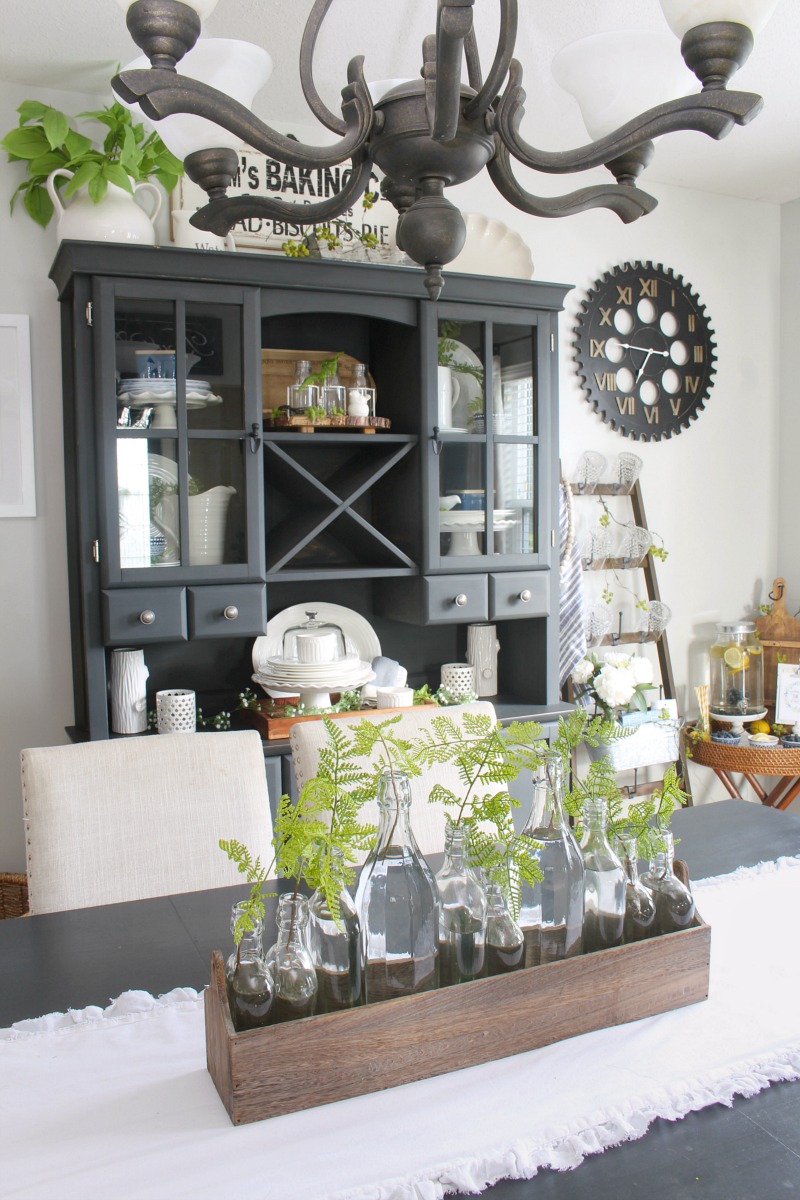 Farmhouse style dining room decorated for summer with blues and greens.
