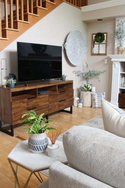 Modern farmhouse style family room with wood television console.