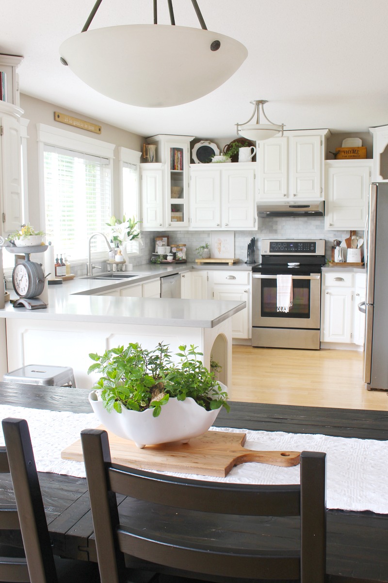 White farmhouse style kitchen decorated for summer.