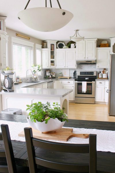 White farmhouse style kitchen decorated for summer.