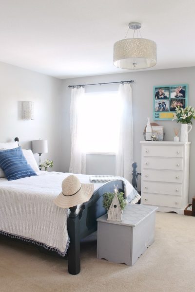 Bedroom decorated for summer with blue and white bedding.