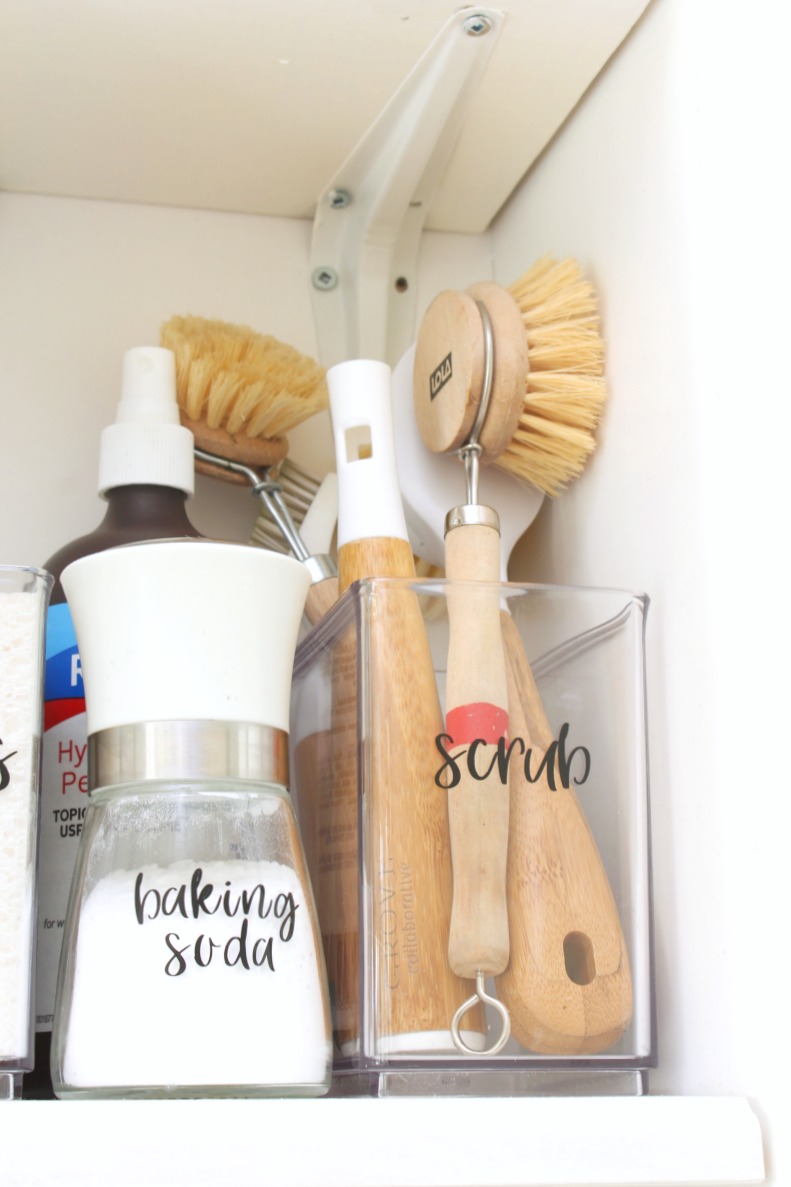 Organized green cleaning supplies with DIY labels.