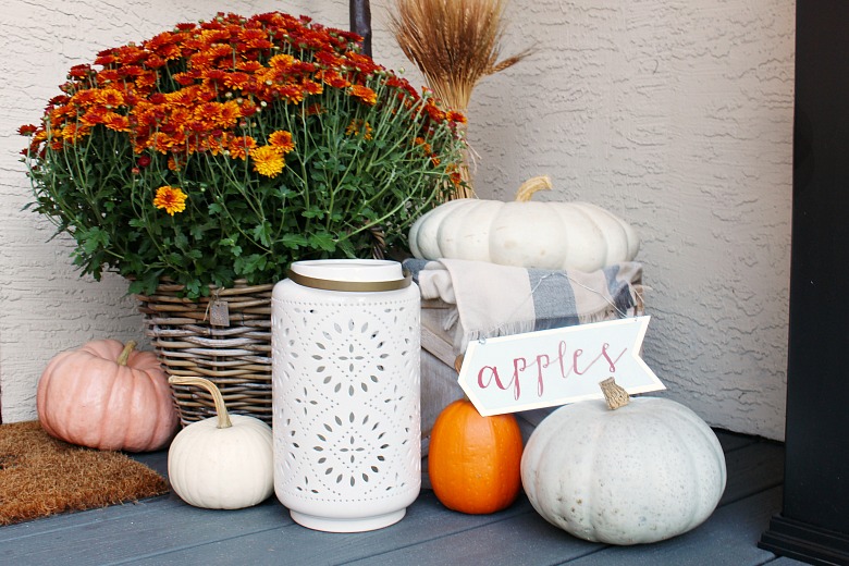 Fall front porch decor with pumpkins and mums.