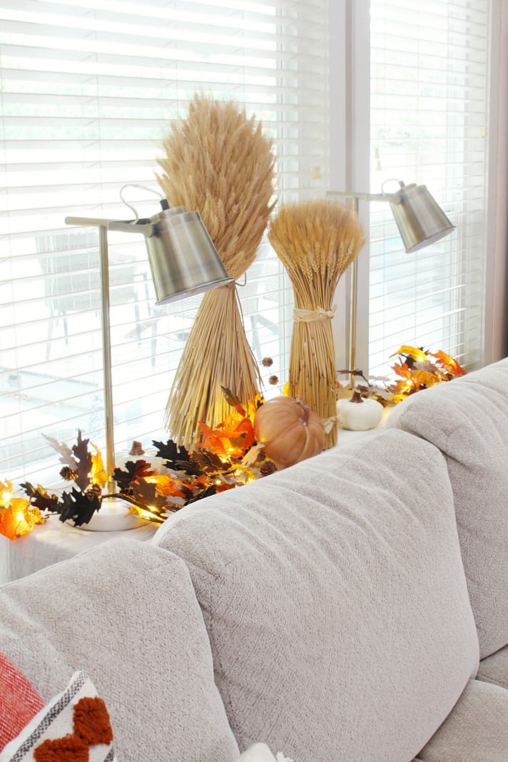 Fall vignette with wheat and fall leaves in a fall living room.