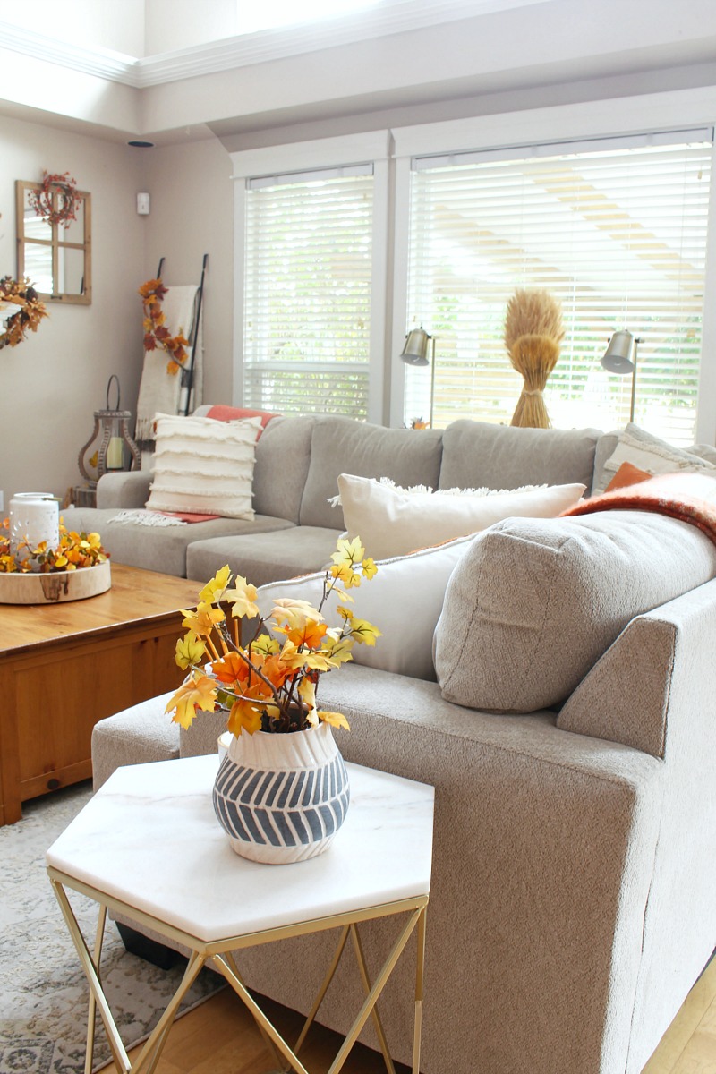 Fall living room with sectional and decorated in traditional fall colors.