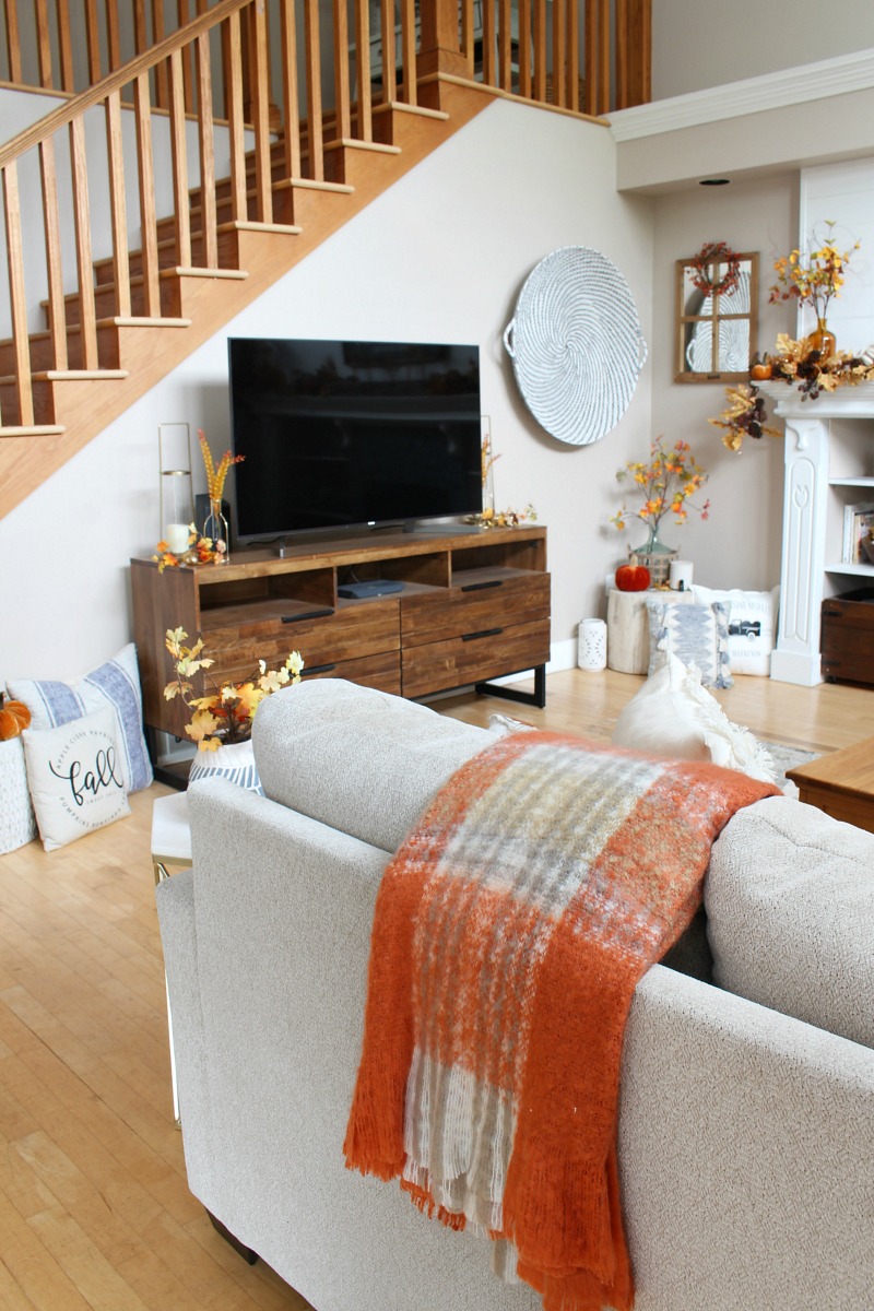 Cozy fall living room with wood television console.