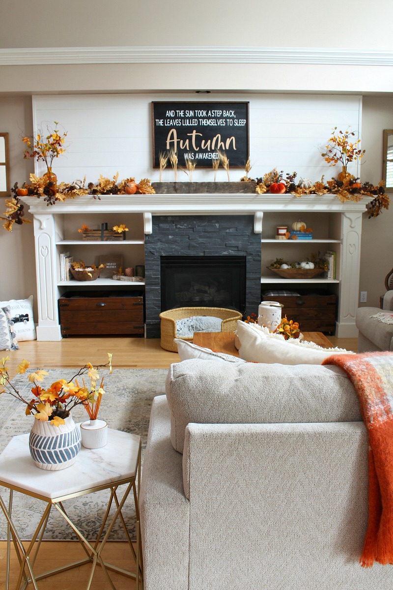 Cozy fall mantel decor ideas using traditional fall colors and lights.