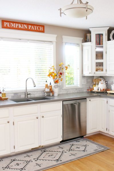 White kitchen with simple fall decor in traditional fall colors.