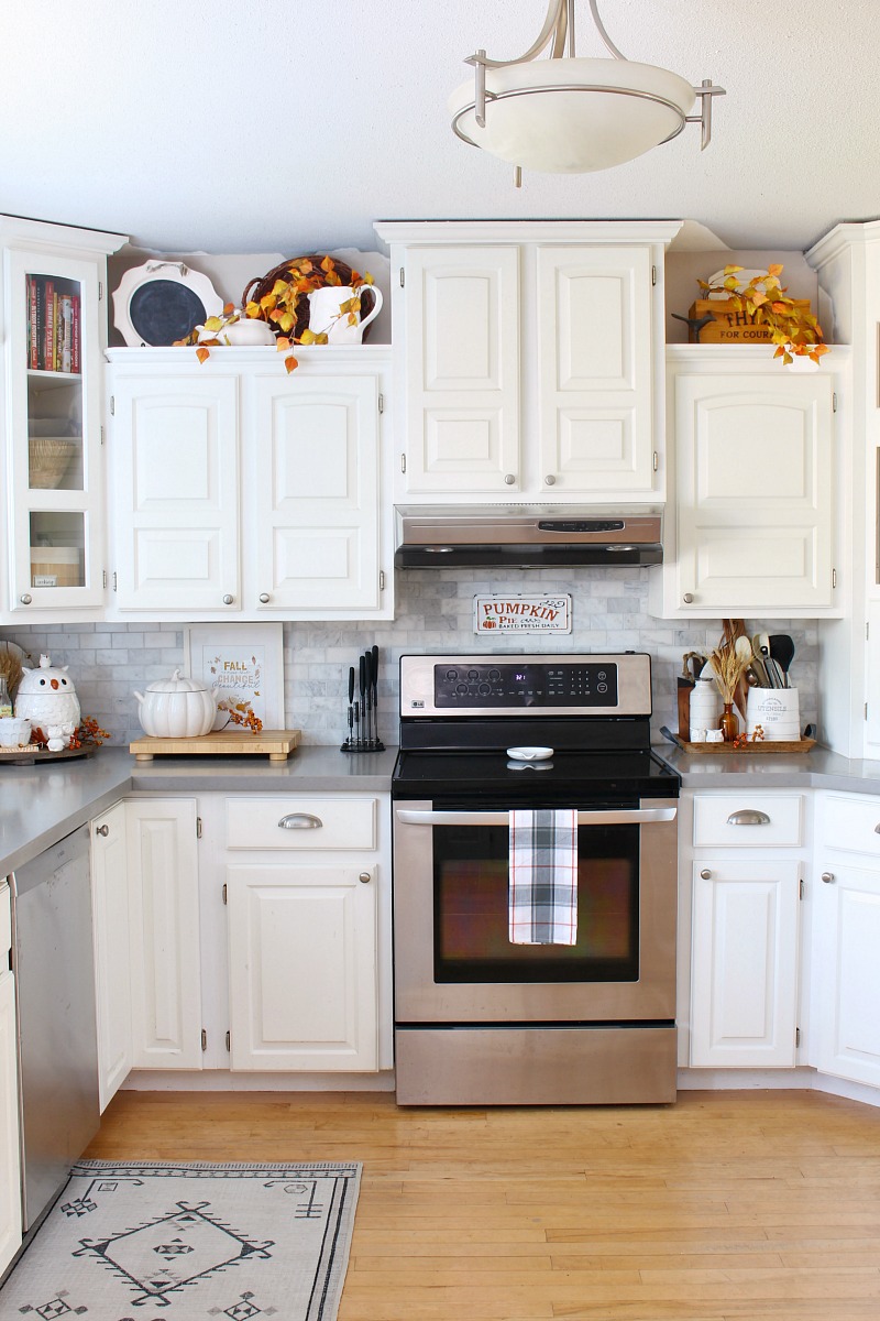 White kitchen with simple fall decor in traditional fall colors.