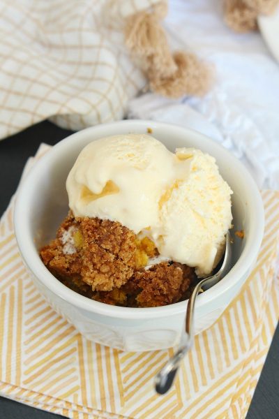 Pumpkin dessert in a bowl with vanilla ice cream.