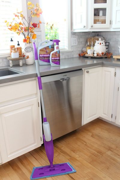 White kitchen decorated for fall with Rejuvenate cleaning products.