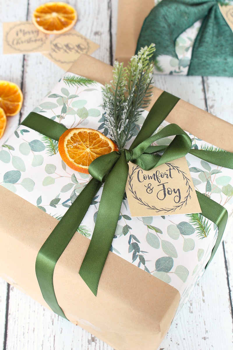 Pretty Christmas present wrapped with kraft paper and layered Christmas gift wrap.