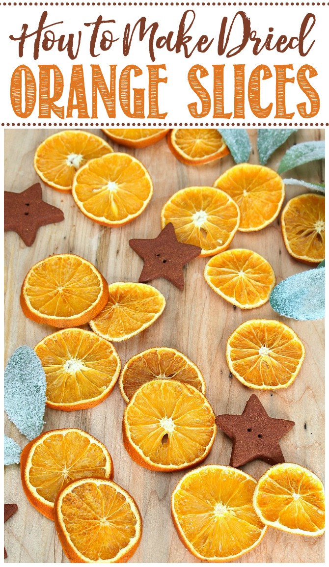 Dried orange slices with cinnamon ornaments on a cutting board.