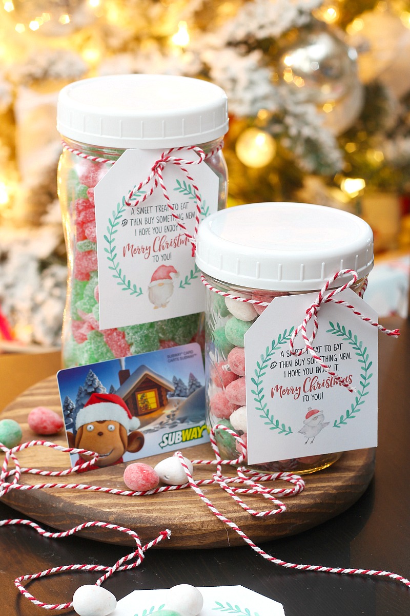 Mason jar filled with Christmas candy and a gift card with a free printable Christmas gift tag.