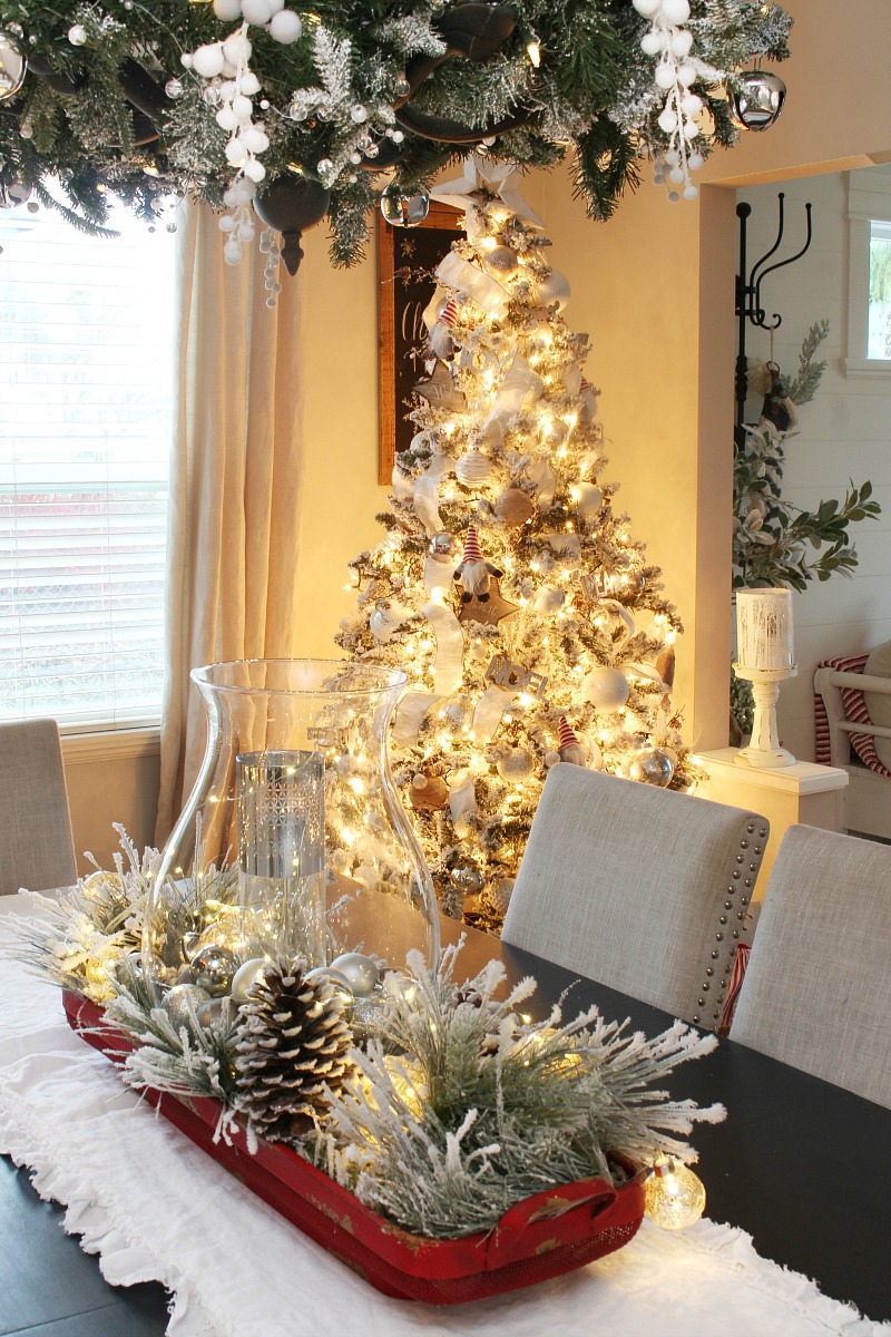 Christmas centerpiece idea with a vintage basket and flocked greenery.
