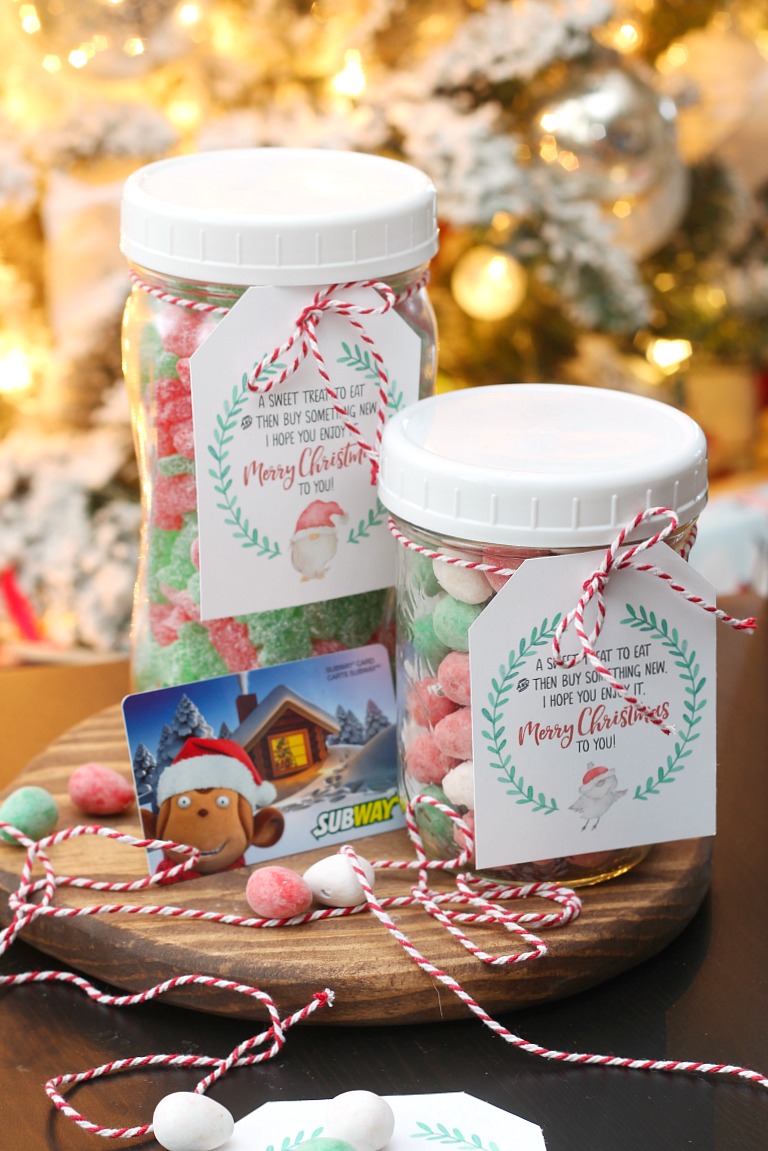 Mason jar filled with Christmas candy and a gift card with a free printable Christmas gift tag.