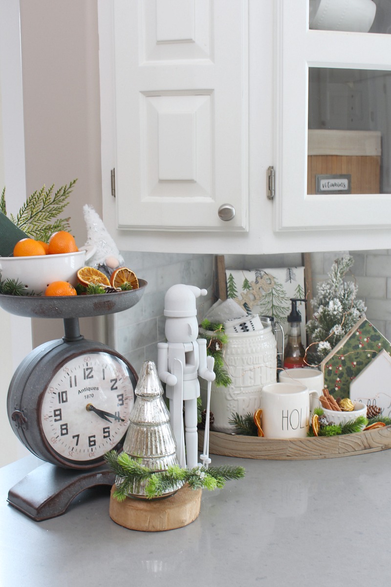 Cute Christmas kitchen decor with oranges and a nutcracker.