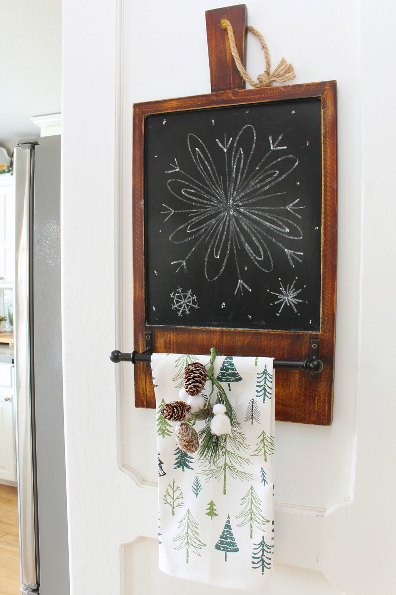 Chalkboard with dish towel holder with a simple Christmas snowflake design.