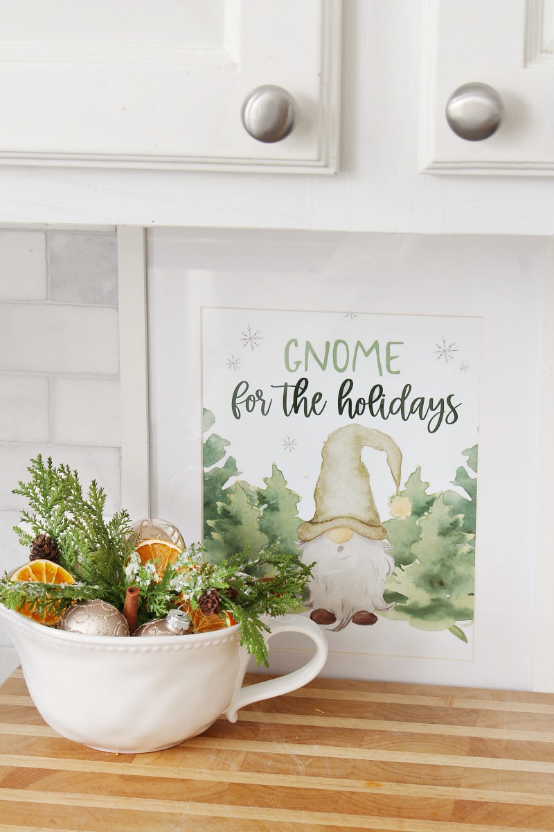 Gnome for the Holidays framed Christmas print with a bowl of greenery and dried oranges.