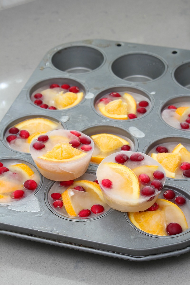 Pretty ice cube cups with cranberries and sliced oranges.