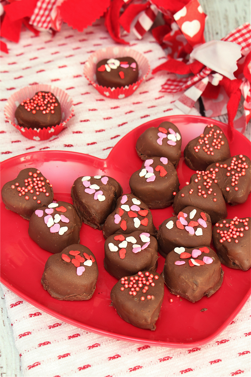 Cute heart-shaped chocolate Oreo truffles on a heart plate for Valentine's Day.
