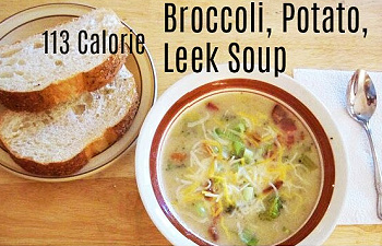 Broccoli, potato, and leek soup served with bread slices.