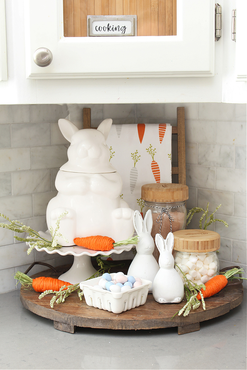 Carrot patch display with white bunnies.