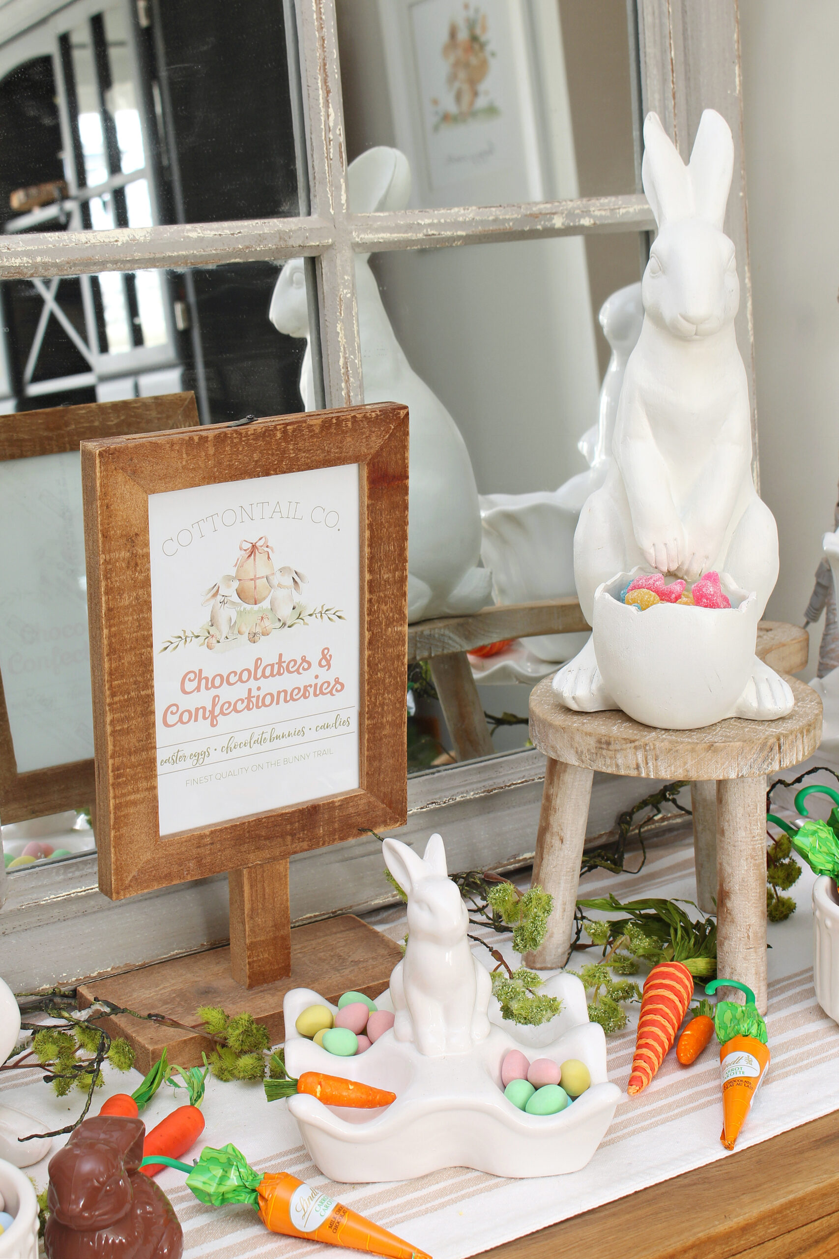 Easter bunny candy bar with white ceramic bunnies and chocolates.