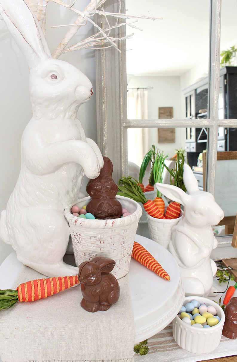 Easter bunny candy bar with white ceramic bunnies and chocolates.